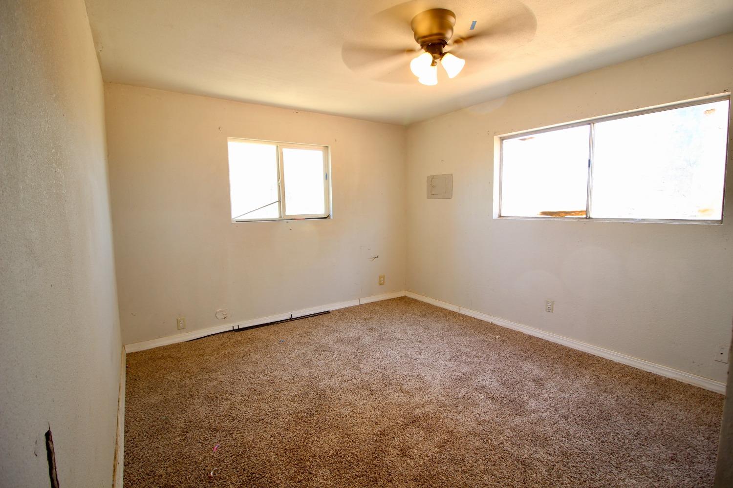 16896 Road 400 Madera, CA 93636 - Photo 13 of 34 an empty room with a window and a ceiling fan