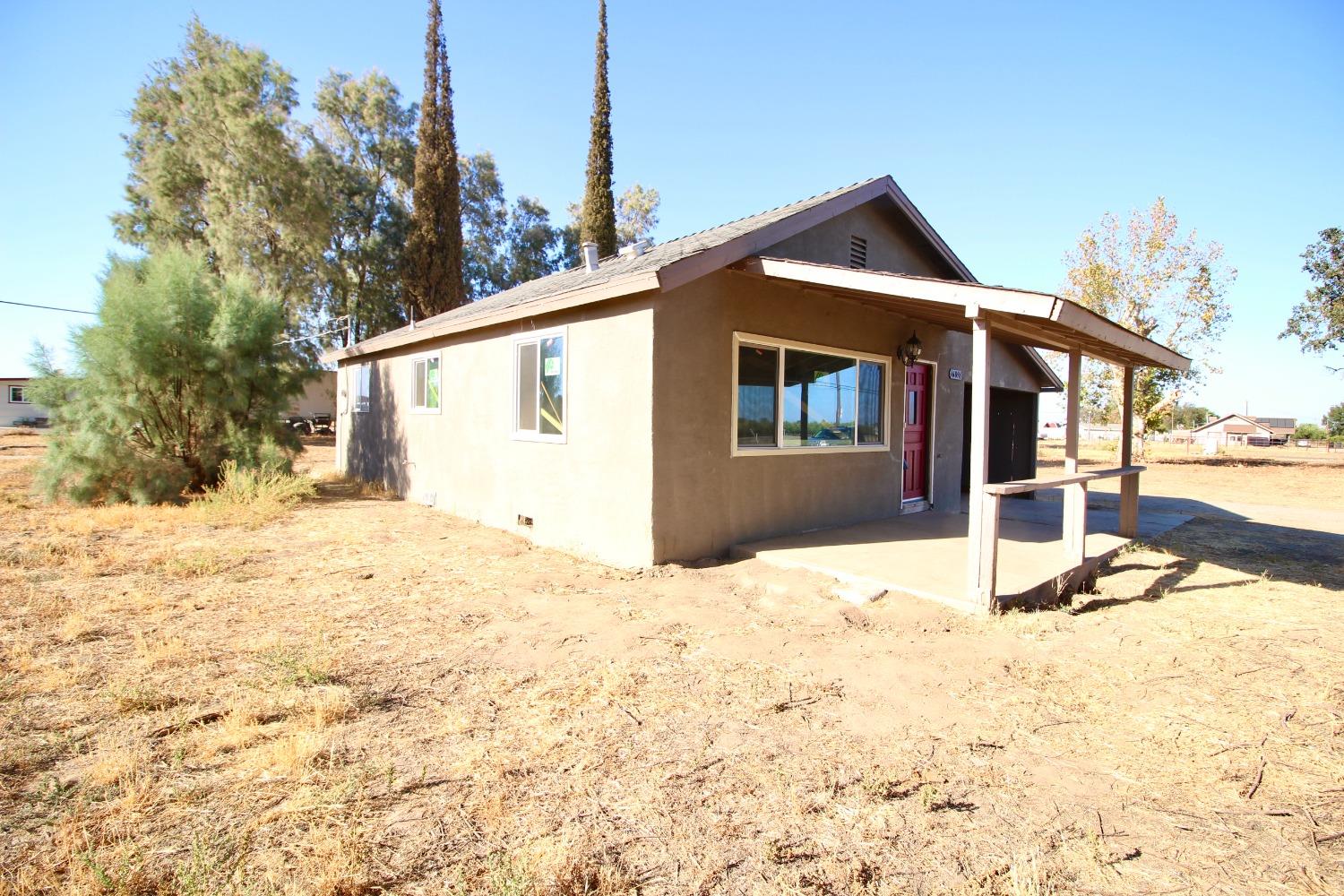 16896 Road 400 Madera, CA 93636 - Photo 7 of 34 a front view of a house with a yard covered in snow