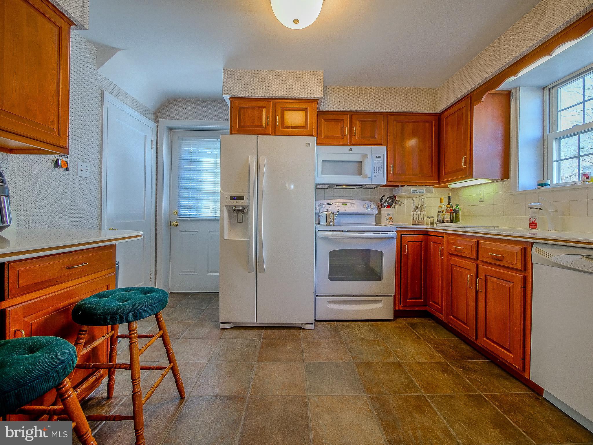 204 East Thomson Avenue Springfield, PA 19064 - Photo 23 of 58 a kitchen with stainless steel appliances granite countertop a refrigerator and a stove top oven