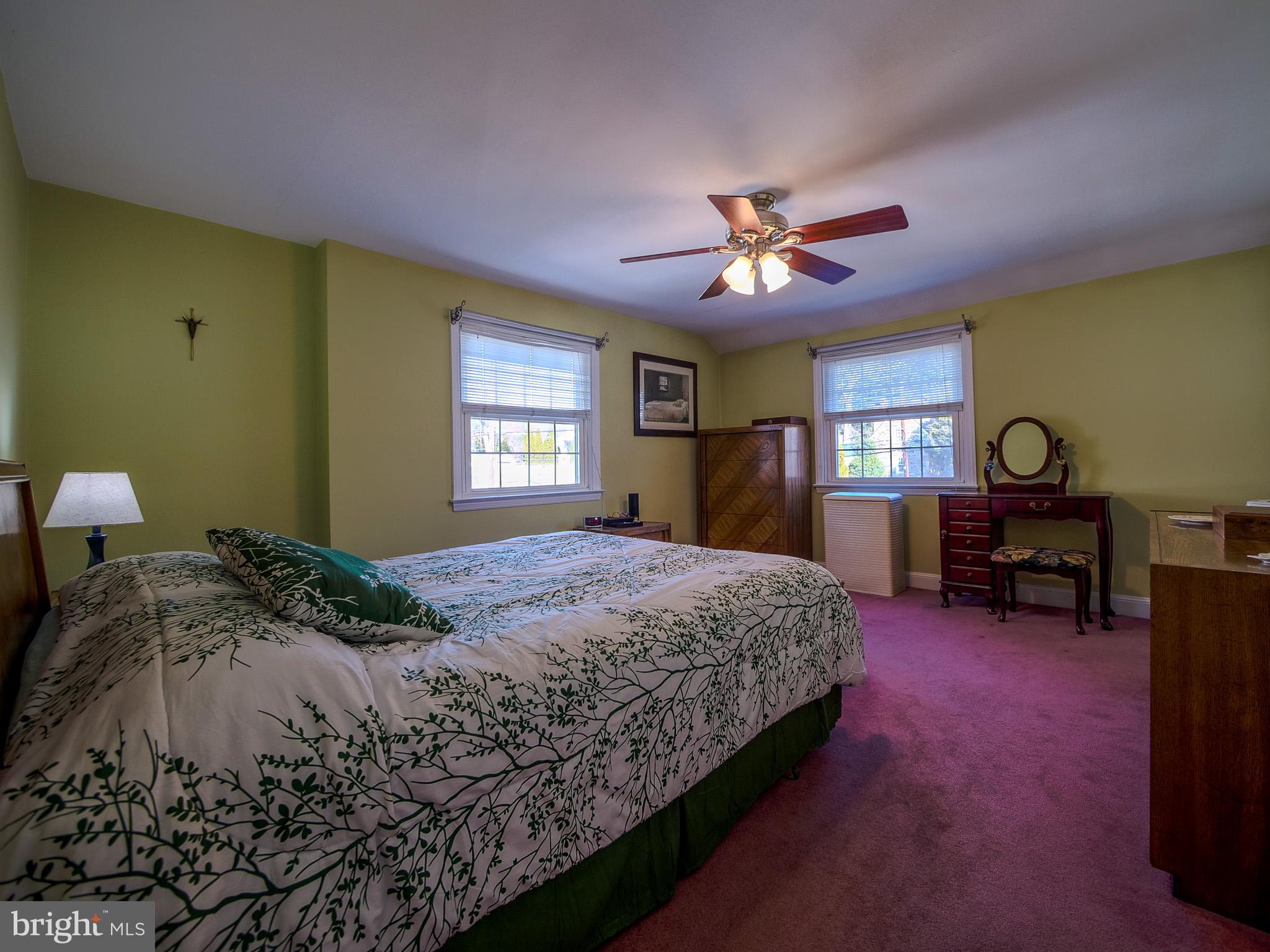 204 East Thomson Avenue Springfield, PA 19064 - Photo 29 of 58 a bedroom with a bed and a chandelier
