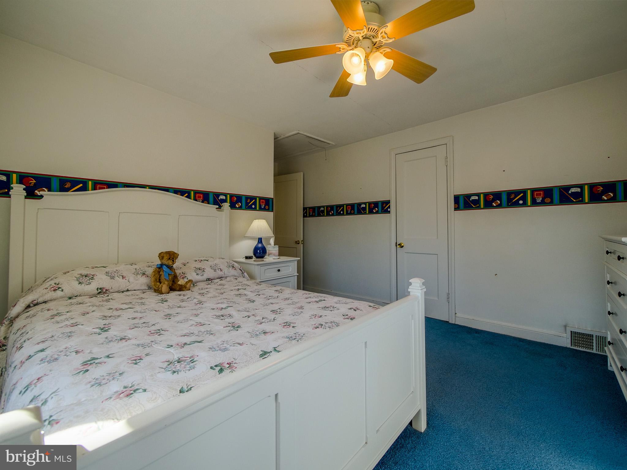 204 East Thomson Avenue Springfield, PA 19064 - Photo 35 of 58 a bedroom with a bed and a chandelier