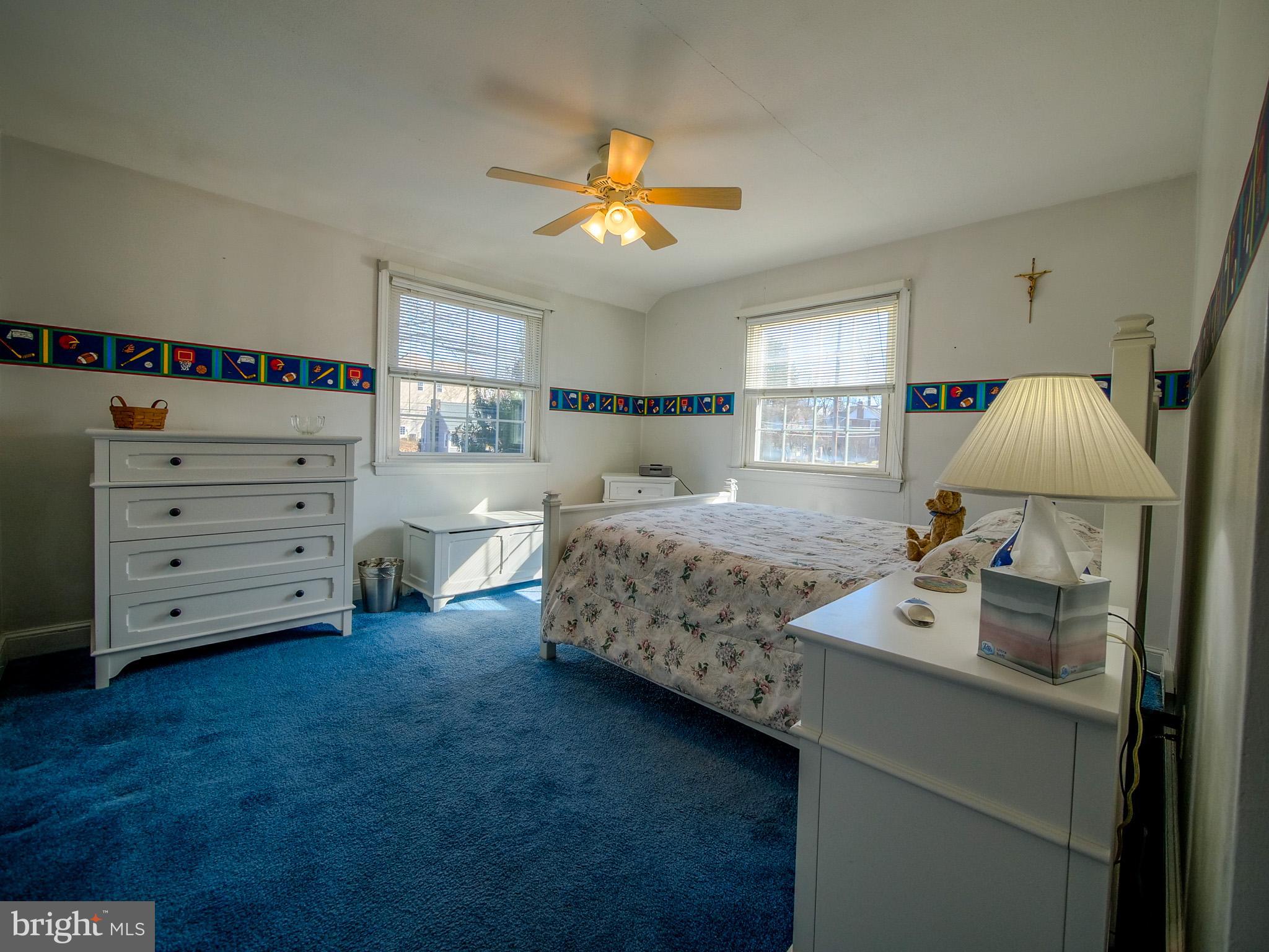 204 East Thomson Avenue Springfield, PA 19064 - Photo 37 of 58 a bedroom with a bed and a chandelier