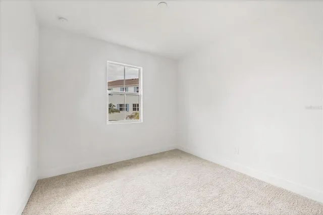 a view of a room with a table and chairs