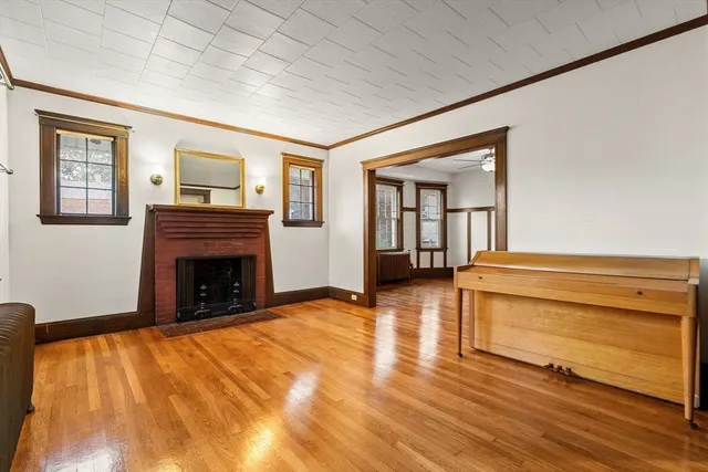 a view of livingroom with fireplace and workspace