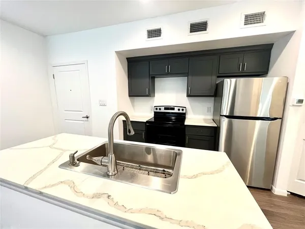 a kitchen with a sink and refrigerator