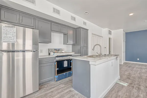 a kitchen with stainless steel appliances granite countertop a sink stove and refrigerator