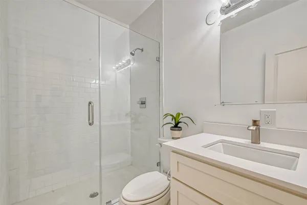 a bathroom with a sink toilet and shower