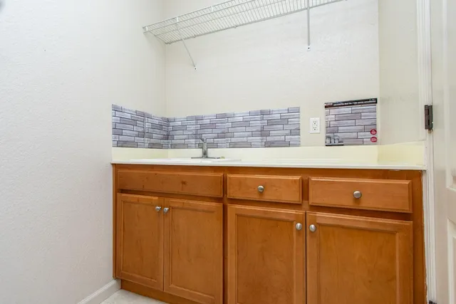a kitchen with stainless steel appliances granite countertop a sink and cabinets