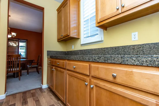 a kitchen with stainless steel appliances granite countertop a sink a stove and a microwave oven