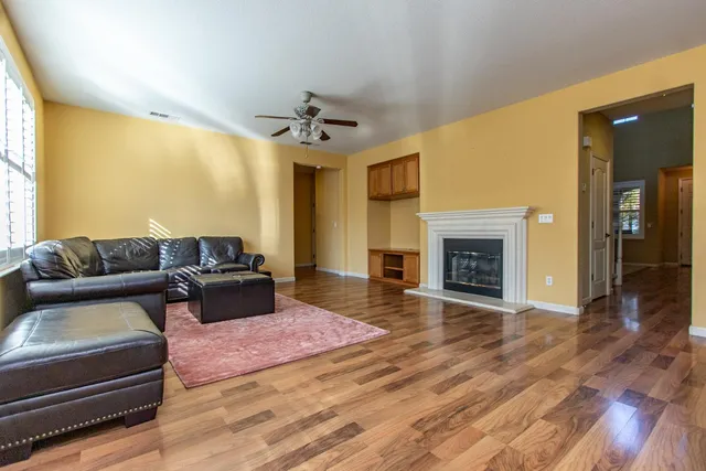 a view of an empty room with a fireplace and a window