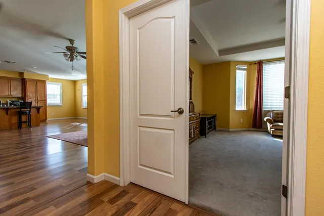 a bathroom with a granite countertop sink a mirror and a bathtub