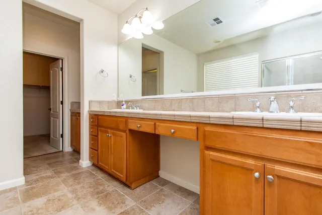 a kitchen with stainless steel appliances a refrigerator a sink dishwasher and a stove with wooden floor