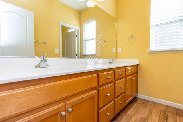 a view of an empty room with chandelier fan