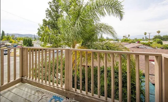 a bedroom with two beds and paintings on the wall