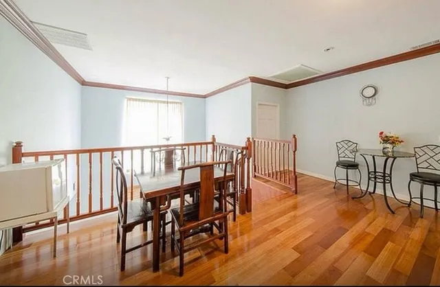 a bedroom with furniture and wooden floor