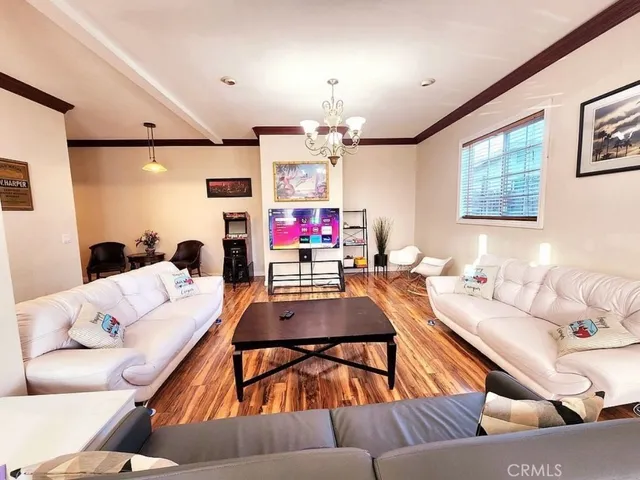 a living room with furniture and a chandelier