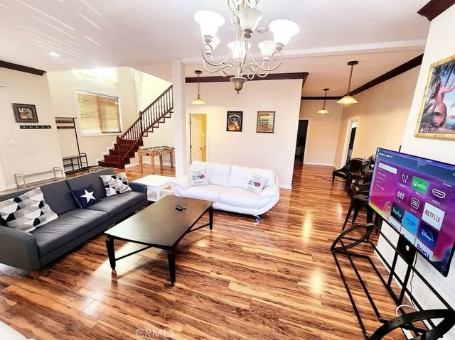 a living room with furniture and wooden floor