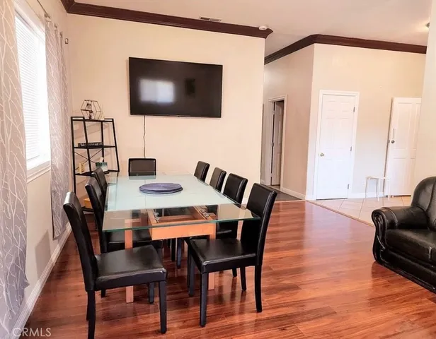 a view of a dining room with furniture and wooden floor