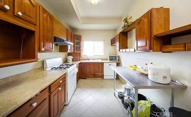 a kitchen with a sink stove and cabinets