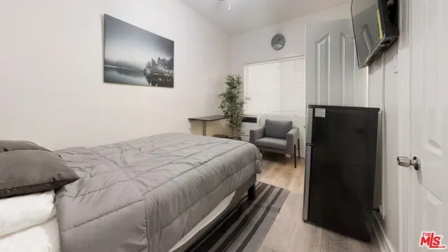 a bedroom with a bed and a couch