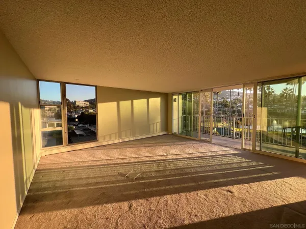 a view of room with wooden floor and windows
