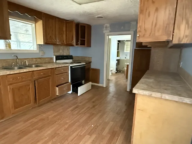 a kitchen with a sink stove and cabinets