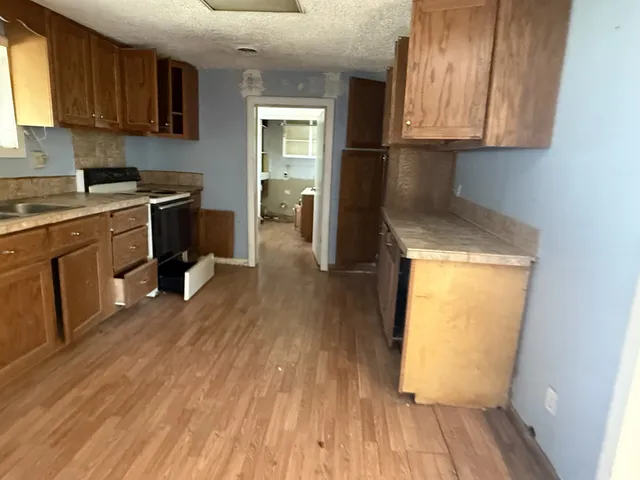 a kitchen with a sink a stove and cabinets