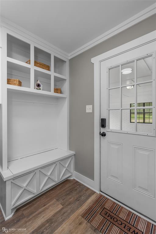 1426 Caney Lake Road Minden, LA 71055 - Photo 23 of 36 Entryway featuring wood-finish flooring, a built-in storage bench with lattice detailing, and overhead cubbies