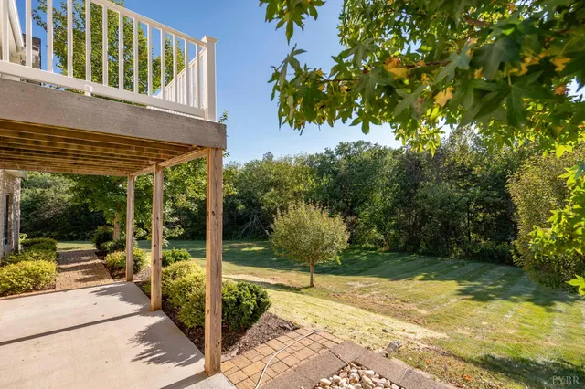 a view of a patio with table and chairs potted plants with wooden fence