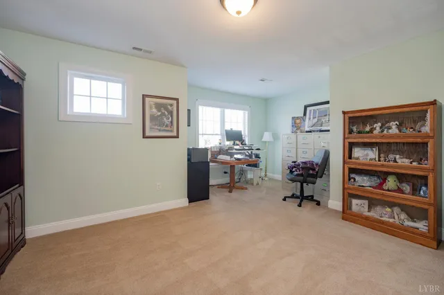 a view of an empty room with cabinet and a bookshelf