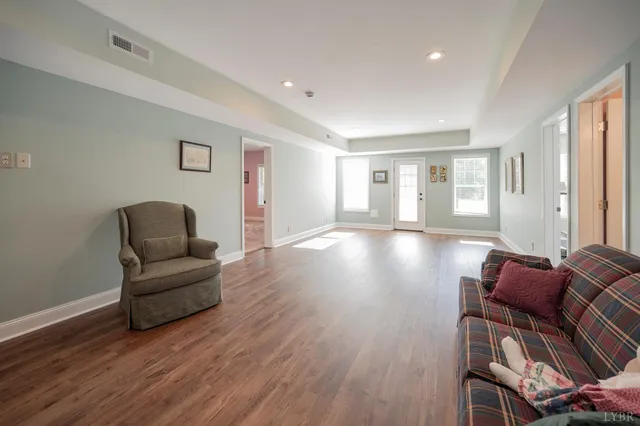 a living room with furniture window and a wooden floor