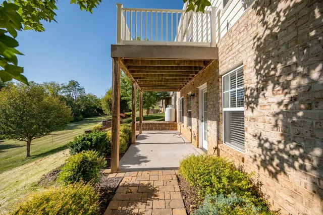 a view of a house with backyard porch and sitting area
