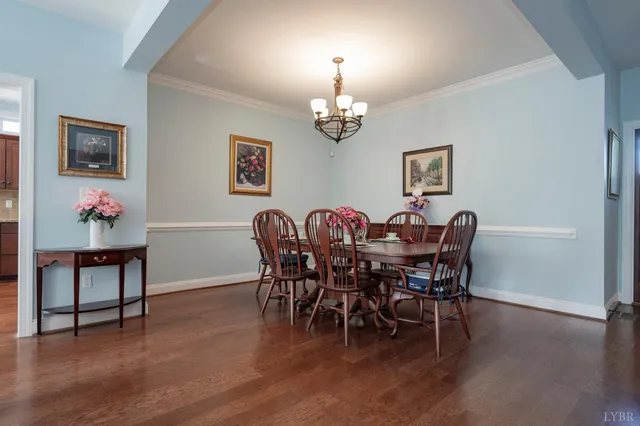 a view of a dining room with furniture and chandelier