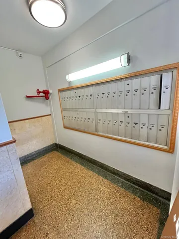 a view of a hallway to a livingroom with furniture