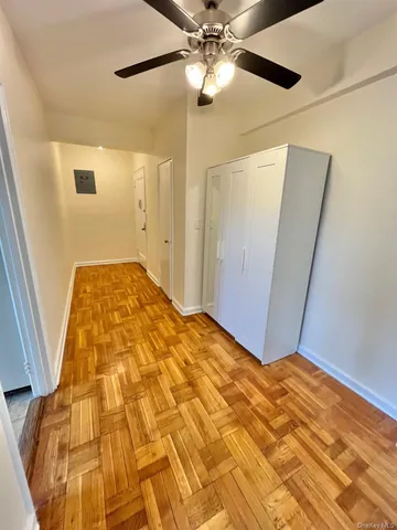 a view of a big room with wooden floor and cabinet in a room