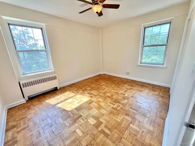 a view of a room with window and hardwood floor