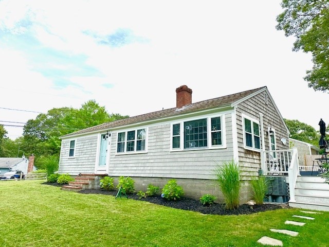 2 Ebb Road Dennis, MA 02660 - Photo 2 of 19 a front view of a house with a yard
