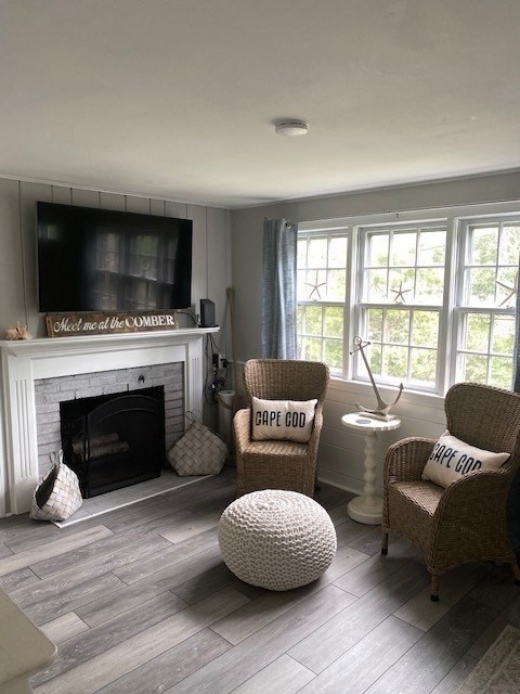 2 Ebb Road Dennis, MA 02660 - Photo 8 of 19 a living room with furniture a flat screen tv and a fireplace