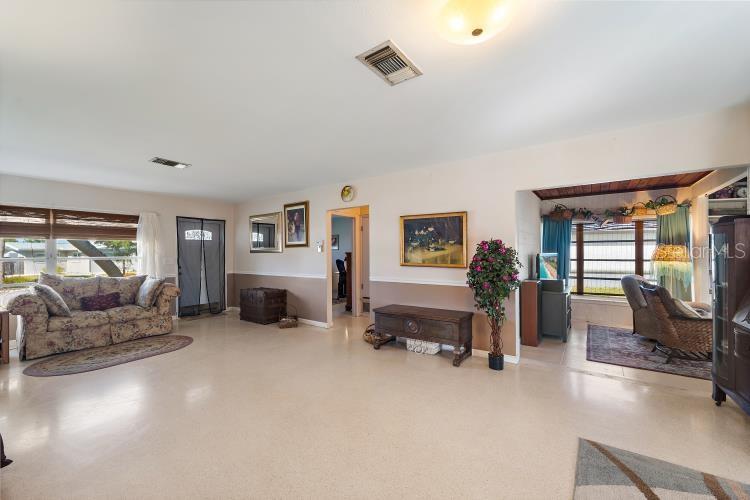 444 Driftwood Road Venice, FL 34293 - Photo 13 of 27 a living room with furniture and a flat screen tv
