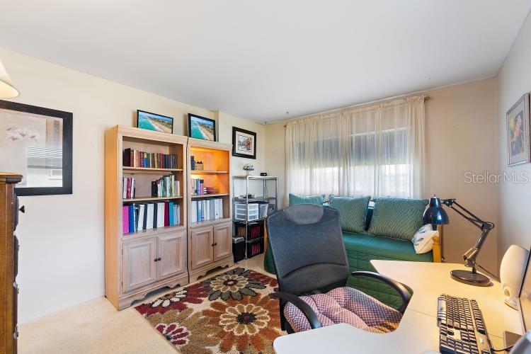 444 Driftwood Road Venice, FL 34293 - Photo 21 of 27 a living room with furniture and a book shelf