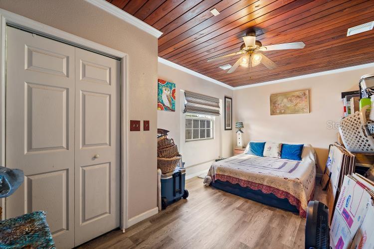 444 Driftwood Road Venice, FL 34293 - Photo 22 of 27 a bedroom with furniture and a chandelier