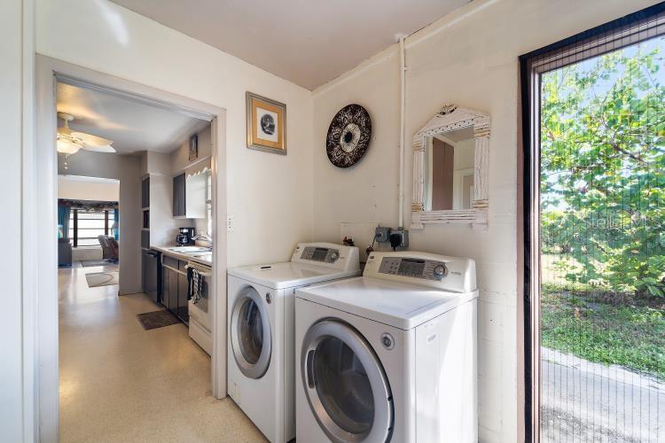 444 Driftwood Road Venice, FL 34293 - Photo 26 of 27 a view of a hallway with washer and dryer