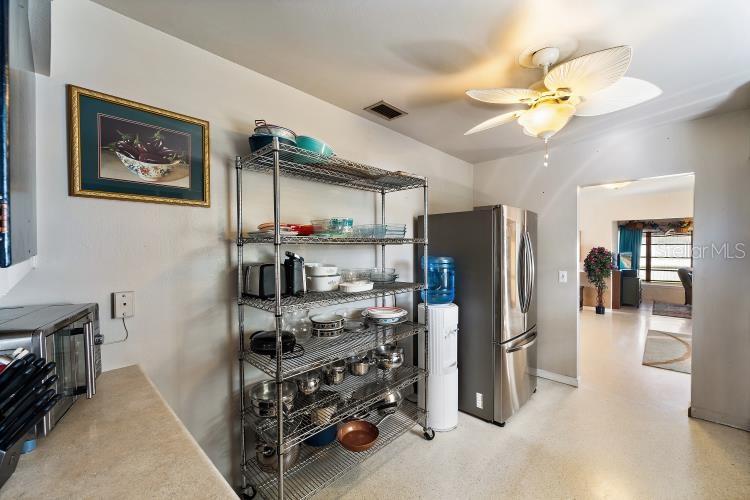 444 Driftwood Road Venice, FL 34293 - Photo 7 of 27 a kitchen with stainless steel appliances granite countertop a refrigerator and a sink
