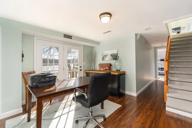 a view of a workspace with furniture and a window