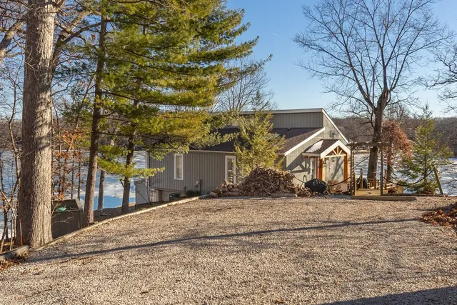 a view of a house with a snow in front of yard