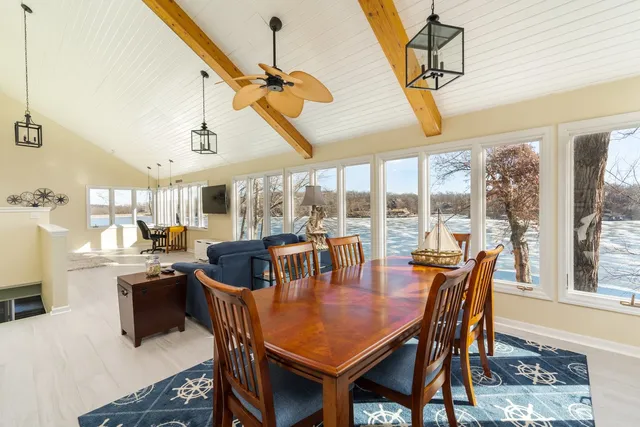a dining room with furniture a chandelier and wooden floor