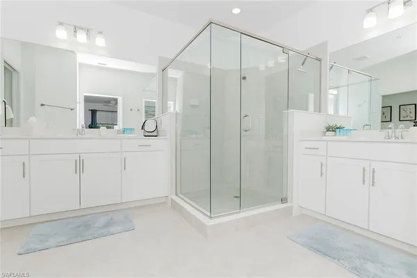 a bathroom with a shower sink and mirror