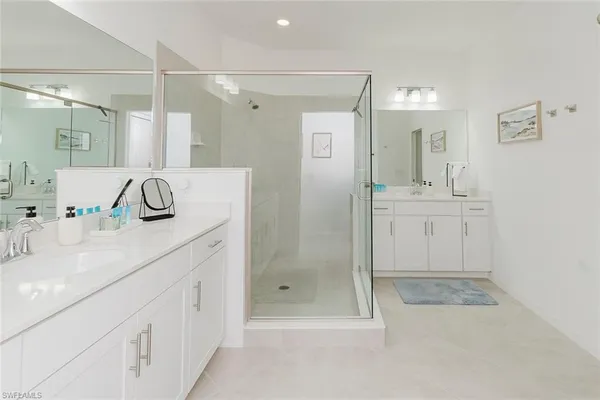 a bathroom with a shower sink and mirror