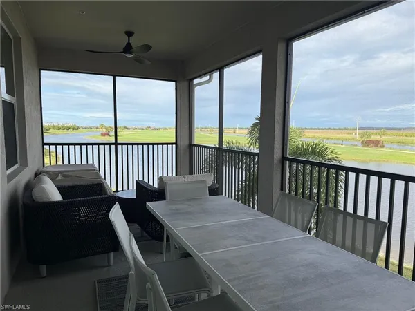 a view of a chairs and table in the balcony
