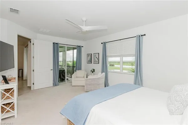 a bedroom with a large bed and a large window